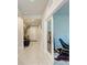 Bright hallway leading to various rooms with tile flooring and natural light, creating a welcoming atmosphere at 1766 Sunset Preserve Way, Port Charlotte, FL 33953