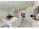 Contemporary kitchen boasting white cabinets, a large island, and stainless steel appliances at 1766 Sunset Preserve Way, Port Charlotte, FL 33953