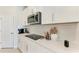 Close-up of a kitchen counter with white subway tile backsplash and modern appliances at 1766 Sunset Preserve Way, Port Charlotte, FL 33953