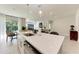 Modern kitchen featuring a quartz countertop island with pendant lighting and stainless steel appliances at 1766 Sunset Preserve Way, Port Charlotte, FL 33953