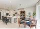 Open concept kitchen and dining area with bar seating and modern appliances at 1766 Sunset Preserve Way, Port Charlotte, FL 33953