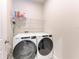 A laundry room with a new Whirlpool washer and dryer and storage shelving above at 1766 Sunset Preserve Way, Port Charlotte, FL 33953