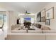 Spacious living room featuring modern furniture, a large TV, neutral decor, and a ceiling fan at 1766 Sunset Preserve Way, Port Charlotte, FL 33953