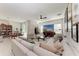 Spacious living room featuring a plush sectional sofa, modern ceiling fan and natural light at 1766 Sunset Preserve Way, Port Charlotte, FL 33953