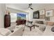 Bright living room featuring stylish decor, a contemporary ceiling fan and a comfortable sofa at 1766 Sunset Preserve Way, Port Charlotte, FL 33953