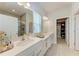 Elegant main bathroom with double vanity, quartz countertop, and walk-in closet at 1766 Sunset Preserve Way, Port Charlotte, FL 33953