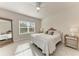 Bright main bedroom with tile flooring, ceiling fan, and a large window at 1766 Sunset Preserve Way, Port Charlotte, FL 33953