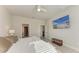 Comfortable main bedroom featuring a ceiling fan, mounted TV, and ensuite bathroom at 1766 Sunset Preserve Way, Port Charlotte, FL 33953