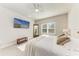 Relaxing main bedroom with ceiling fan, mounted TV, and lots of natural light at 1766 Sunset Preserve Way, Port Charlotte, FL 33953