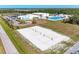 Aerial view of community volleyball courts adjacent to a pool and recreation center, perfect for active living at 1766 Sunset Preserve Way, Port Charlotte, FL 33953