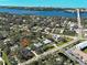 Overhead view of a home nestled in a tree-filled neighborhood near the water at 1769 Manasota Beach Rd, Englewood, FL 34223