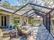 Spacious screened-in patio with above ground pool, lounge seating, and a grill at 1769 Manasota Beach Rd, Englewood, FL 34223