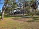 A sprawling backyard featuring an enclosed lanai at 1769 Manasota Beach Rd, Englewood, FL 34223