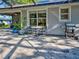 Backyard patio area with gas grill and view of the house at 1769 Manasota Beach Rd, Englewood, FL 34223