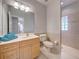 Bright bathroom with vanity, tile floor, and glass block shower window at 1769 Manasota Beach Rd, Englewood, FL 34223