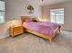 Comfortable bedroom with a large bed, neutral colors, carpet flooring, and natural light from windows at 1769 Manasota Beach Rd, Englewood, FL 34223
