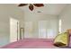 Spacious bedroom with a leaf-shaped ceiling fan, neutral walls, and plush bedding for a comfortable and stylish retreat at 1769 Manasota Beach Rd, Englewood, FL 34223