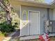 Exterior of the house with a side door and utility connections at 1769 Manasota Beach Rd, Englewood, FL 34223