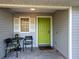 Cozy covered front porch with seating area and charming decor at 1769 Manasota Beach Rd, Englewood, FL 34223