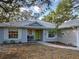 Inviting front porch with seating area and lush landscaping at 1769 Manasota Beach Rd, Englewood, FL 34223