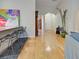 Hallway with hardwood floors, white walls, and arched doorways offers open feel at 1769 Manasota Beach Rd, Englewood, FL 34223