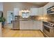 Kitchen featuring stainless steel dishwasher, granite countertops, and white cabinets at 1769 Manasota Beach Rd, Englewood, FL 34223