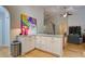Bright kitchen with island and granite countertops and stainless steel trash can at 1769 Manasota Beach Rd, Englewood, FL 34223