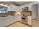 Modern kitchen with stainless appliances, granite counters, and white cabinetry at 1769 Manasota Beach Rd, Englewood, FL 34223
