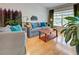 Inviting living room with stylish decor, plush sofas, wood floors, and a large window with natural lighting at 1769 Manasota Beach Rd, Englewood, FL 34223