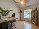 Well-lit home office with wood floors, closet, and ceiling fan at 1769 Manasota Beach Rd, Englewood, FL 34223