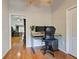 Home office with modern desk, wood floors, and convenient access at 1769 Manasota Beach Rd, Englewood, FL 34223