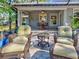 Inviting covered patio with wicker furniture, perfect for enjoying the outdoors while staying cool and comfortable at 1769 Manasota Beach Rd, Englewood, FL 34223