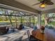 Inviting outdoor dining and lounge area under a screened lanai, perfect for enjoying the Florida weather at 1769 Manasota Beach Rd, Englewood, FL 34223