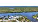 Breathtaking aerial view of waterfront home, private dock, lush landscaping, and access to beautiful scenic waterways at 18382 Arapahoe Cir, Port Charlotte, FL 33948