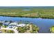 Aerial view of waterfront home with private dock situated on a beautiful canal at 18382 Arapahoe Cir, Port Charlotte, FL 33948