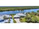 Desirable waterfront property with beautiful landscaping and an attached two-car garage at 18382 Arapahoe Cir, Port Charlotte, FL 33948