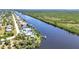 Picturesque aerial view of waterfront homes along a canal, showcasing waterfront living at 18382 Arapahoe Cir, Port Charlotte, FL 33948