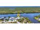 Stunning aerial view of a waterfront property with lush surroundings and direct water access at 18382 Arapahoe Cir, Port Charlotte, FL 33948