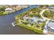 Aerial showcase of canal-front home with a private dock, pool and meticulously landscaped backyard at 18382 Arapahoe Cir, Port Charlotte, FL 33948