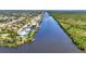 Stunning aerial shot showcases canal homes with boat docks, exemplifying waterfront living at 18382 Arapahoe Cir, Port Charlotte, FL 33948