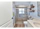 Bathroom featuring a glass enclosed shower, wooden shelves, and vinyl wood-look flooring at 18382 Arapahoe Cir, Port Charlotte, FL 33948