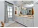 Elegant bathroom featuring double vanity, neutral tiles, and stylish lighting at 18382 Arapahoe Cir, Port Charlotte, FL 33948