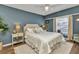 Serene bedroom with a plush bed, blue accent wall, and natural light at 18382 Arapahoe Cir, Port Charlotte, FL 33948