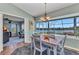 Lovely dining area with a charming chandelier and views of the beautiful backyard and water at 18382 Arapahoe Cir, Port Charlotte, FL 33948