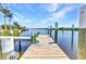 This property features a private wooden dock and canal waterway access at 18382 Arapahoe Cir, Port Charlotte, FL 33948