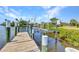 Private dock with boat lift on a calm canal, offering convenient access to the water and scenic views at 18382 Arapahoe Cir, Port Charlotte, FL 33948