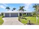Beautiful single Gathering home featuring a two car garage, mature landscaping and pristine lawn at 18382 Arapahoe Cir, Port Charlotte, FL 33948