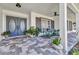 Charming front porch featuring stylish tile flooring, comfortable seating, and elegant double doors at 18382 Arapahoe Cir, Port Charlotte, FL 33948