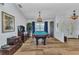 Spacious game room features a pool table, hardwood floors, and custom lighting at 18382 Arapahoe Cir, Port Charlotte, FL 33948