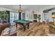 This game room boasts custom lighting, hardwood floors, and a stylish pool table at 18382 Arapahoe Cir, Port Charlotte, FL 33948